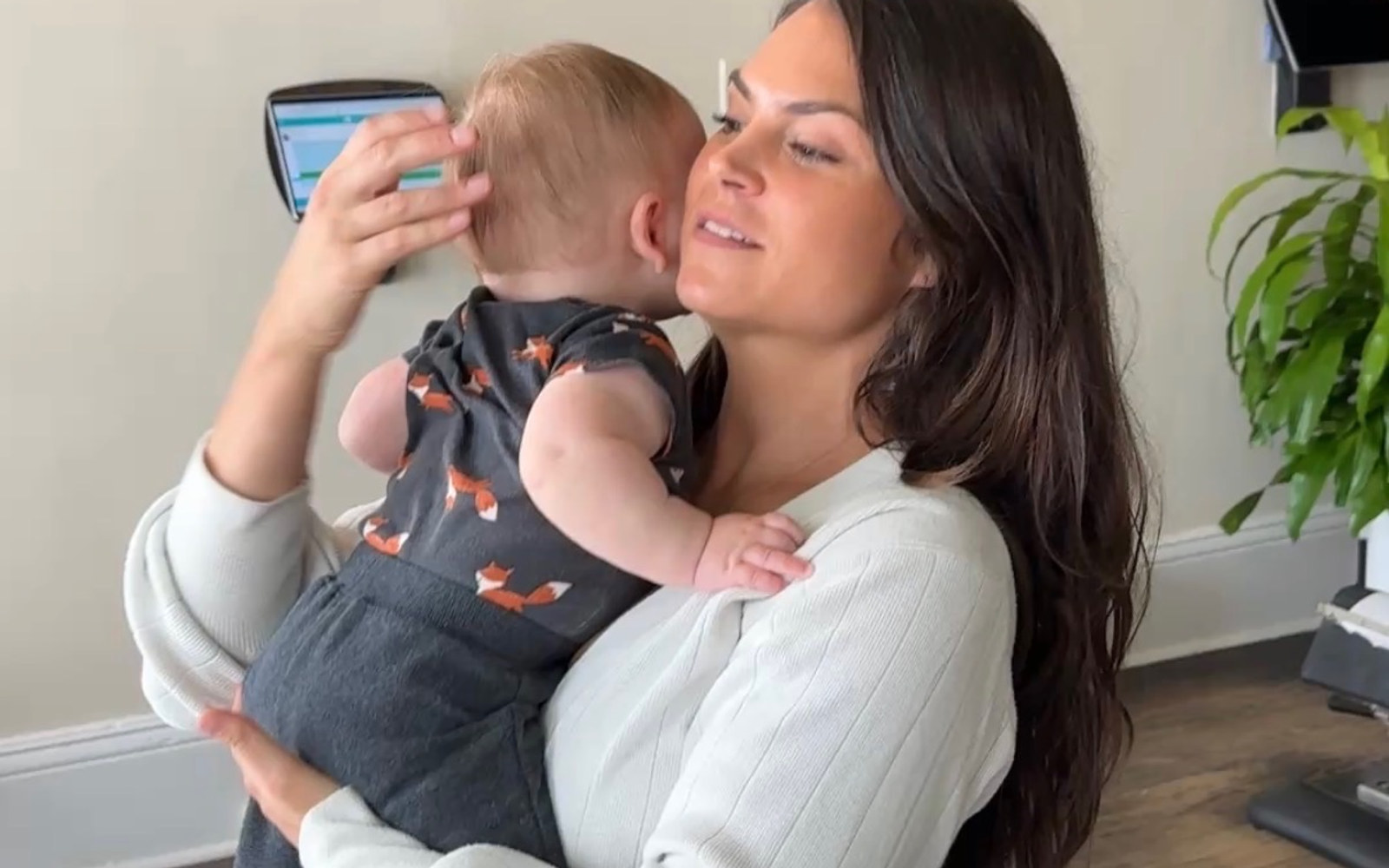 A mother holding her baby at Even Flow Chiropractic in Woodstock, GA